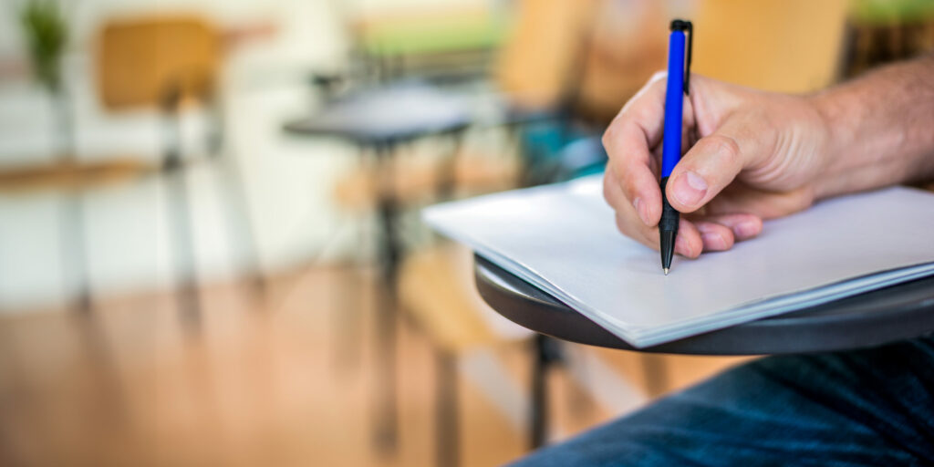 hand antecknar viktiga datum för gymnasieansökan